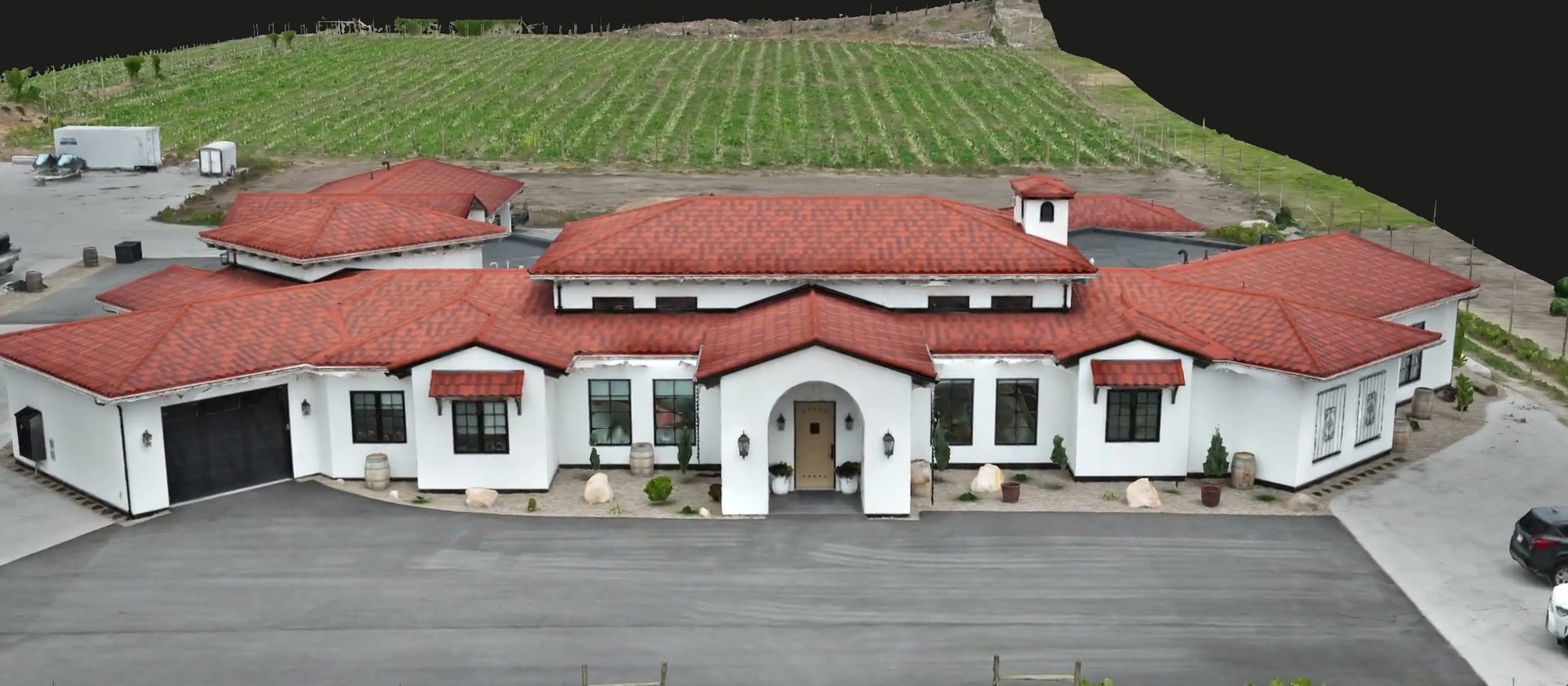 Wide aerial of a rural property with fields and outbuildings, ranching and rural property imagery.