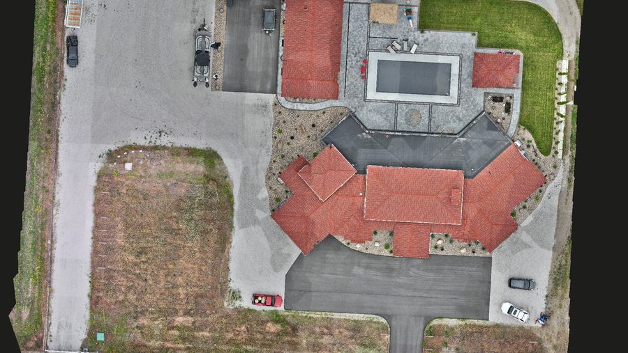 A property mapped from above: roofs, pool and grounds in one seamless image.