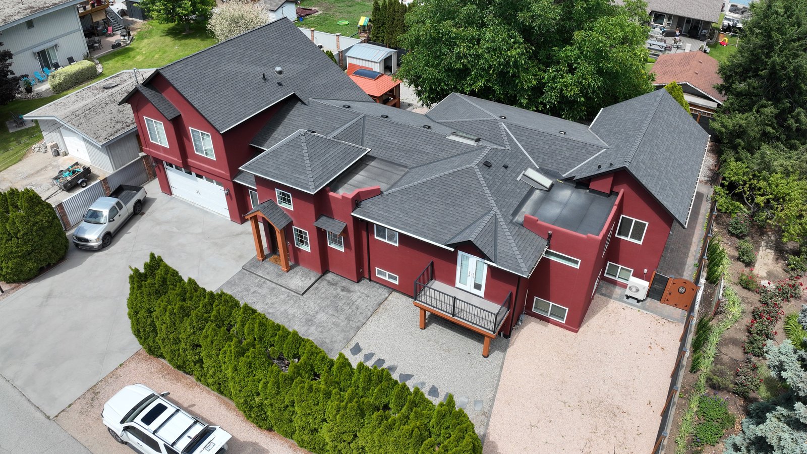 Close aerial oblique of a house and its rooflines, the single-structure detail a record begins with. Demonstration capture.