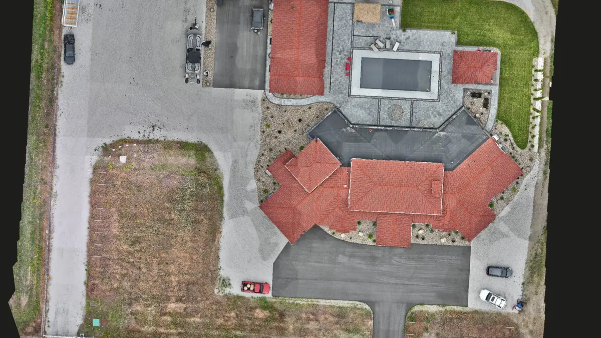 A property mapped from above: terracotta roof, pool and grounds in one seamless image.